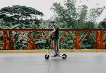 An adult riding an electric scooter
