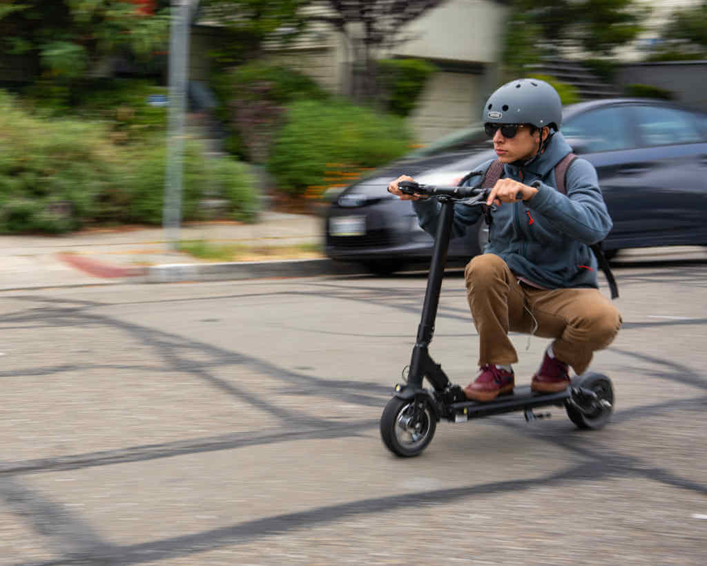 Man riding Fluid FreeRide Horizon electric scooter