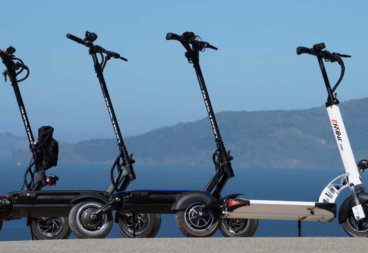 Four electric scooters lined up in a row