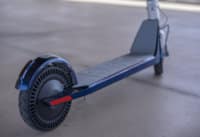 Lower half of Model One Electric scooter with deck, wheels, and logo