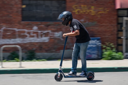 Man riding the Unagi Model One electric scooter