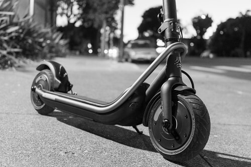 Black and white photo of the Boosted Rev electric scooter by night