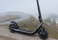 Rev electric scooter overlooking mountains