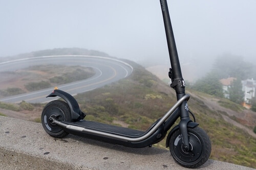 Rev electric scooter overlooking mountains