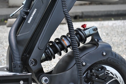 Close up of Dualtron X coil-over-hydraulic suspension