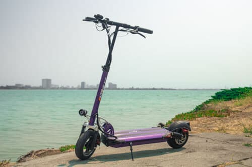 EMOVE Cruiser electric scooter near the water