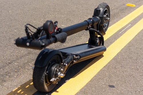 Electric scooter folded on road