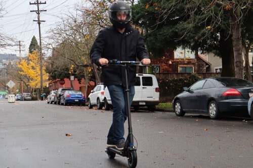 Man accelerating on the Swift electric scooter