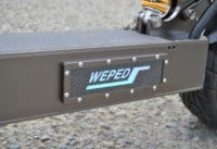 Close up of an electric scooter deck with Weped logo on the side