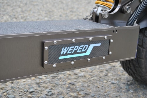Close up of an electric scooter deck with Weped logo on the side