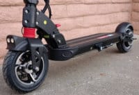 Lower half of an electric scooter showing tires and brakes