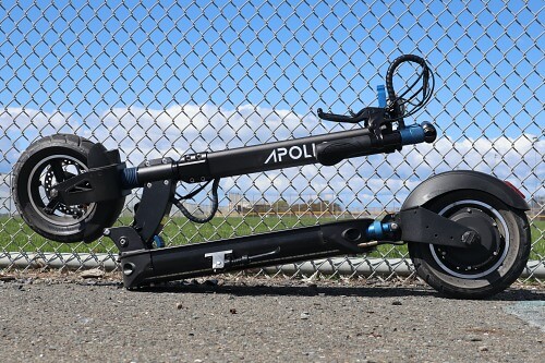 Explore electric scooter folded in front of fence