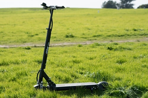 EMOVE Touring electric scooter in a field of grass