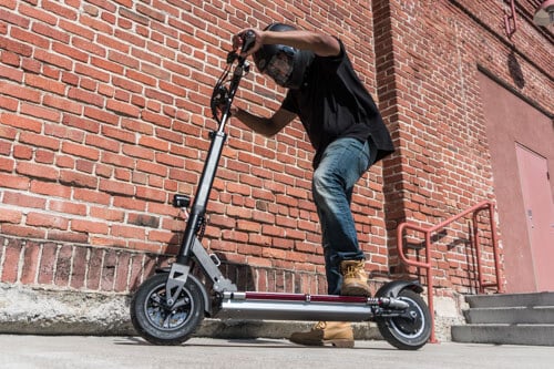 Man riding EVOLV XL Plus electric scooter