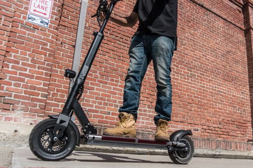 Man accelerating on the EVOLV Tour XL Plus electric scooter