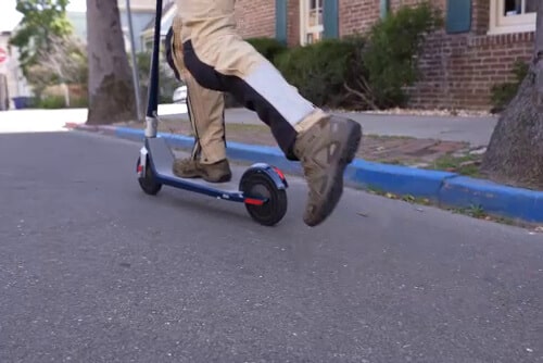 Man kicking off on an electric scooter
