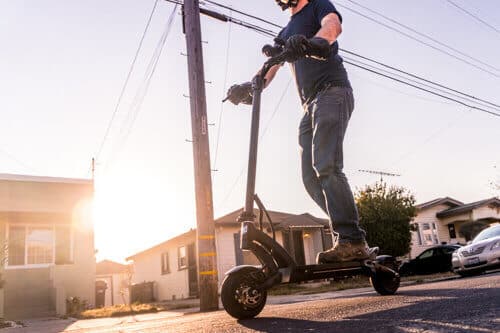 Kaabo-Mantis-8-electric-scooter-man-riding-on-street