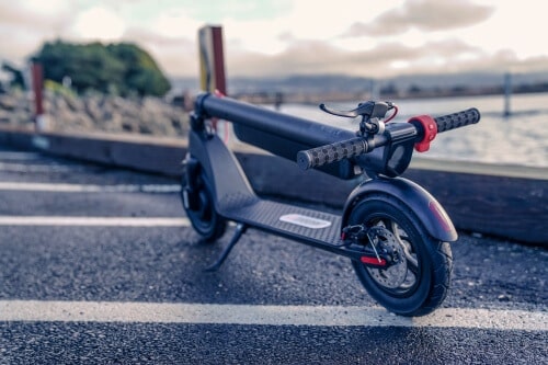 TurboAnt X7 Pro Electric Scooter -full scooter, folded down and clipped to fender, angled view