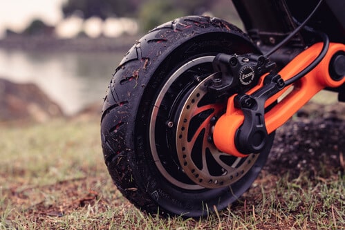 Inokim OXO Electric Scooter - front tire (dirty), hydraulic brake, disc brake, swingarm, close-up