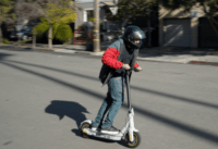 Segway Ninebot Max G30LP Electric Scooter - Man riding scooter, full view, riding to camera