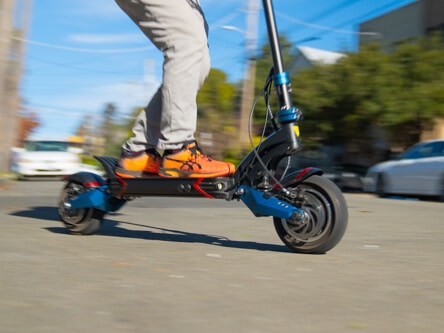 Man racing on the Apollo Pro 60V electric scooter