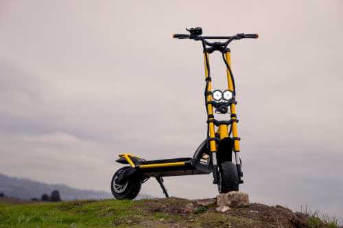Kaabo Wolf King electric scooter - lights on, full scooter, sky in background