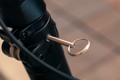 Apollo Phantom electric scooter - folding mechanism pin close-up, cropped