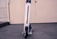 Segway Ninebot Air T15 electric scooter - stem light on, red, front view, limited view, cropped