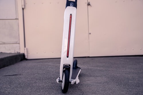 Segway Ninebot Air T15 electric scooter - stem light on, red, front view, limited view, cropped