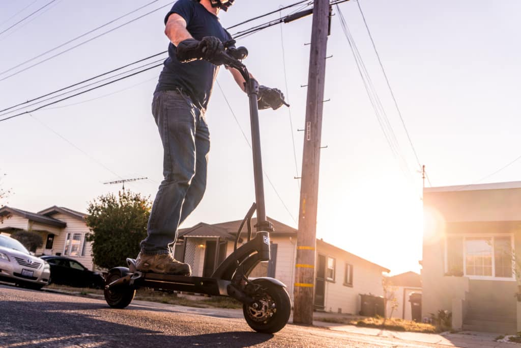 Kaabo Mantis 8 Pro electric scooter - full scooter with man riding, cropped