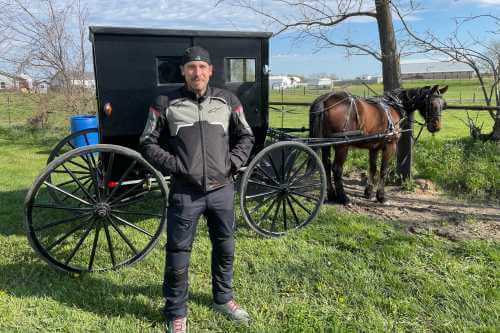 Alex Simon standing in front of horse and buggy