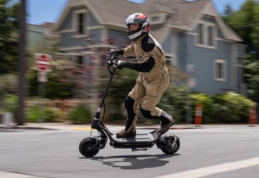 Man racing the NAMI Burn-E electric scooter
