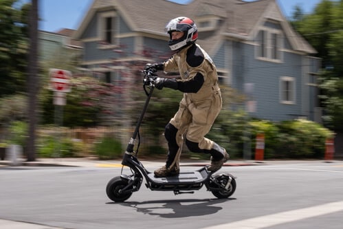 Man racing the NAMI Burn-E electric scooter