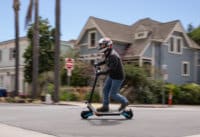 Man accelerating on on Varla Pegasus electric scooter