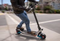 Man accelerating out of corner on Pegasus electric scooter