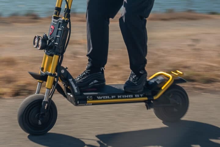 Man riding the Wolf GT electric scooter fast