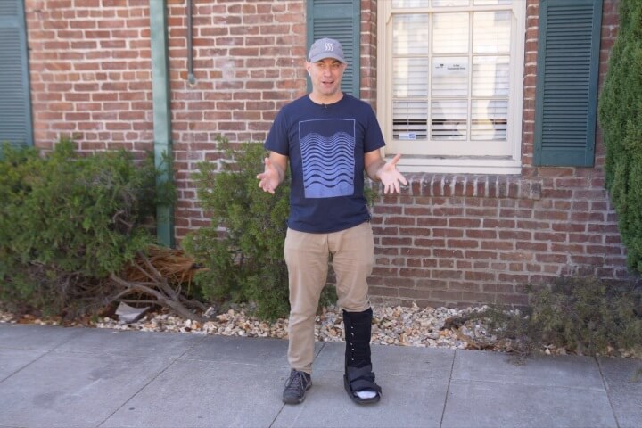 Man with broken ankle talking to camera