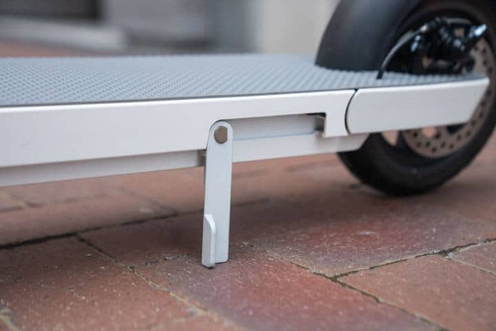 Close up of Okai Neon e-scooter silver kickstand