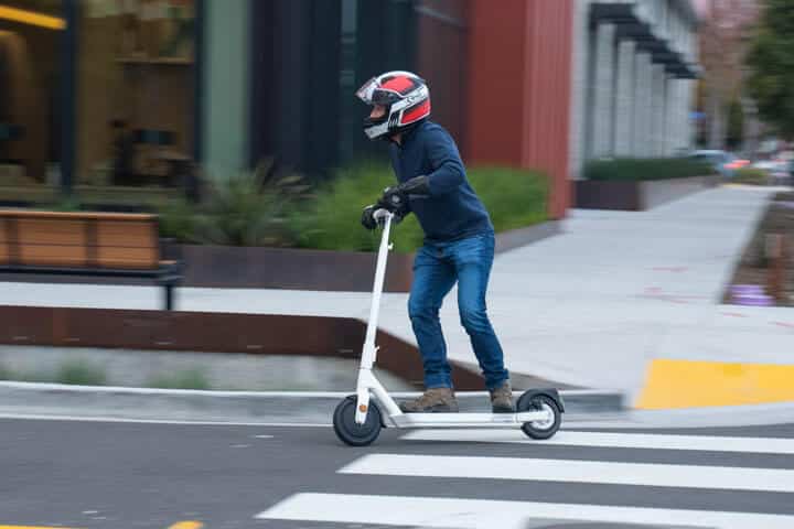 Man turning fast on an Okai Neon electric scooter