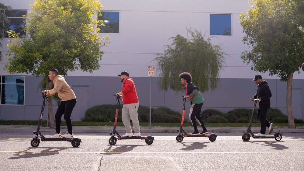 a line of electric scooter riders